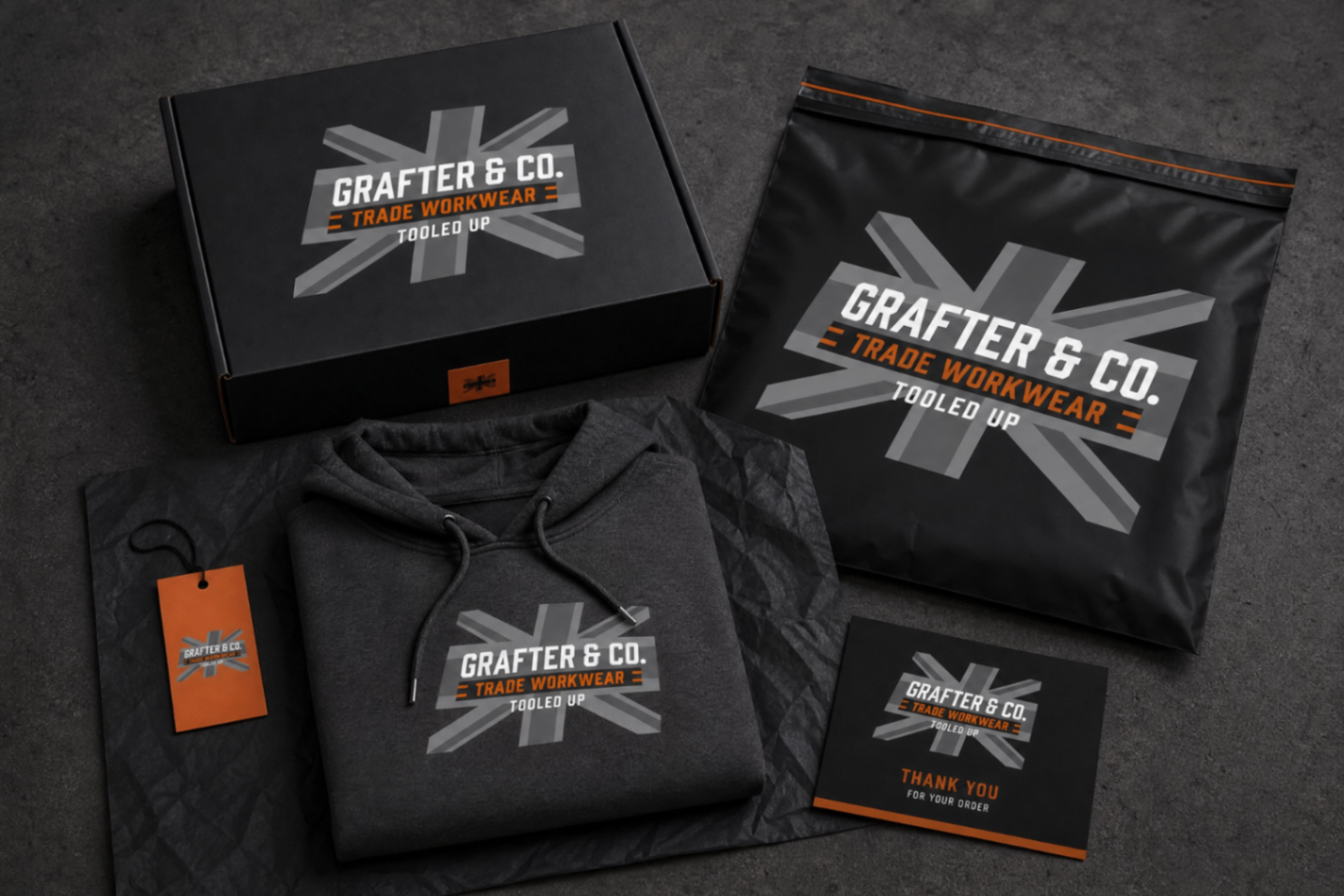 Full Grafter & Co. packaging set including mailer box, mailing bag, tissue wrap, swing tag, thank you card and folded hoodie