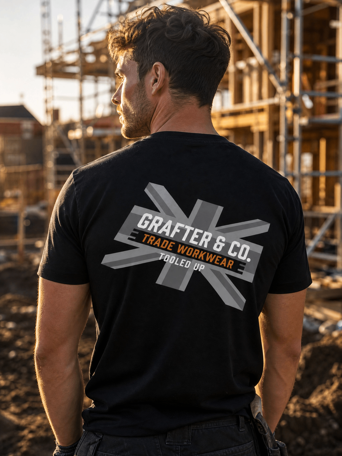 Tradesman on a construction site wearing a black Grafter & Co. tee with large union jack back print